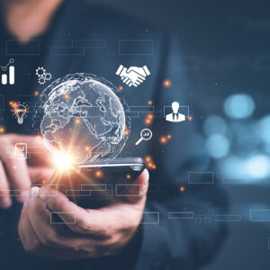 A businessman looking at a smartphone screen filled with icons and business-related symbols.