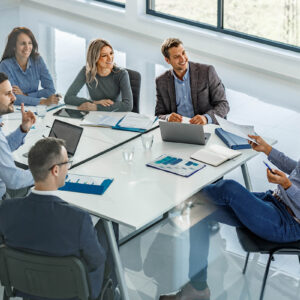 Office colleagues gathered around a conference table for a discussion.