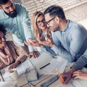 Business professionals collaborating in a meeting room setting.