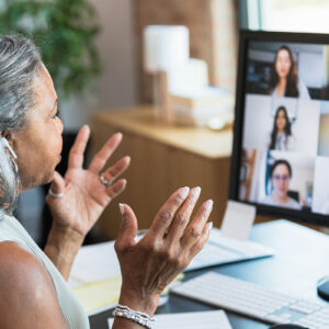 A businesswoman leading a video call with other people.
