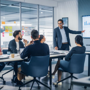 A man presenting to a group in a meeting room.