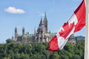 Canadian flag waving with Ottawa's Parliament buildings in the background